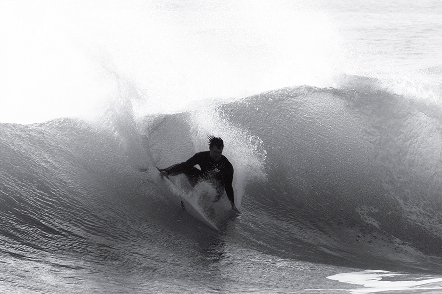 Dane Reynolds deep inside a barrel, black and white